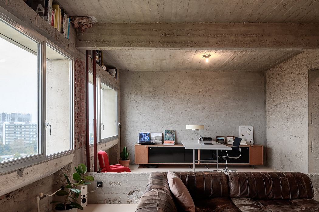 Modern minimalist office space with raw concrete walls and city view.