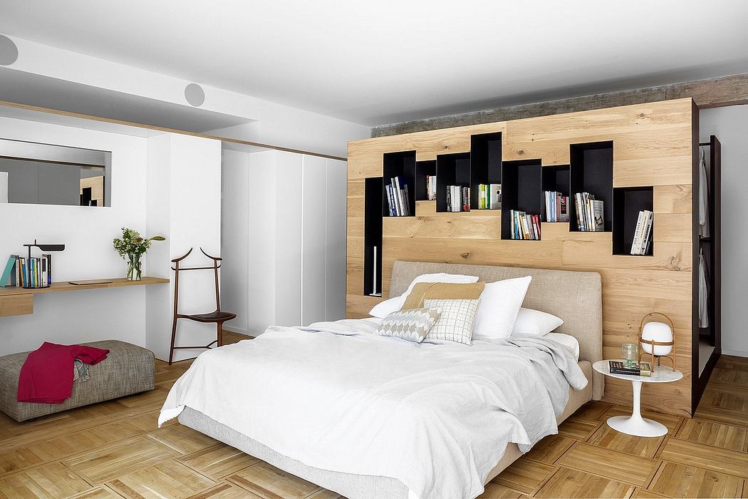 Cozy bedroom with wood-paneled walls, floating shelves, and a plush, upholstered bed.