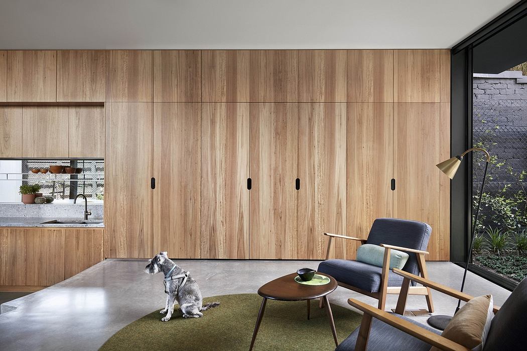 Minimalist wooden paneled walls, built-in storage, and mid-century inspired furniture.
