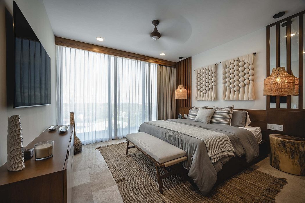 Modern bedroom with a sea view, neutral tones, and artistic decor.