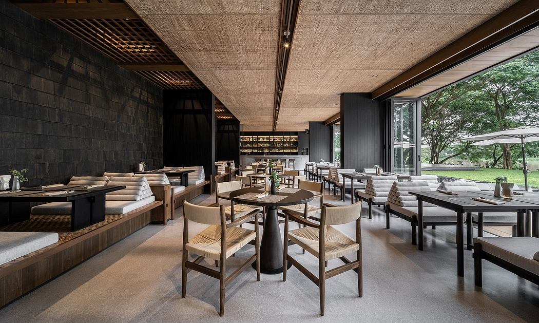 Modern restaurant interior with elegant wooden furniture and large windows.
