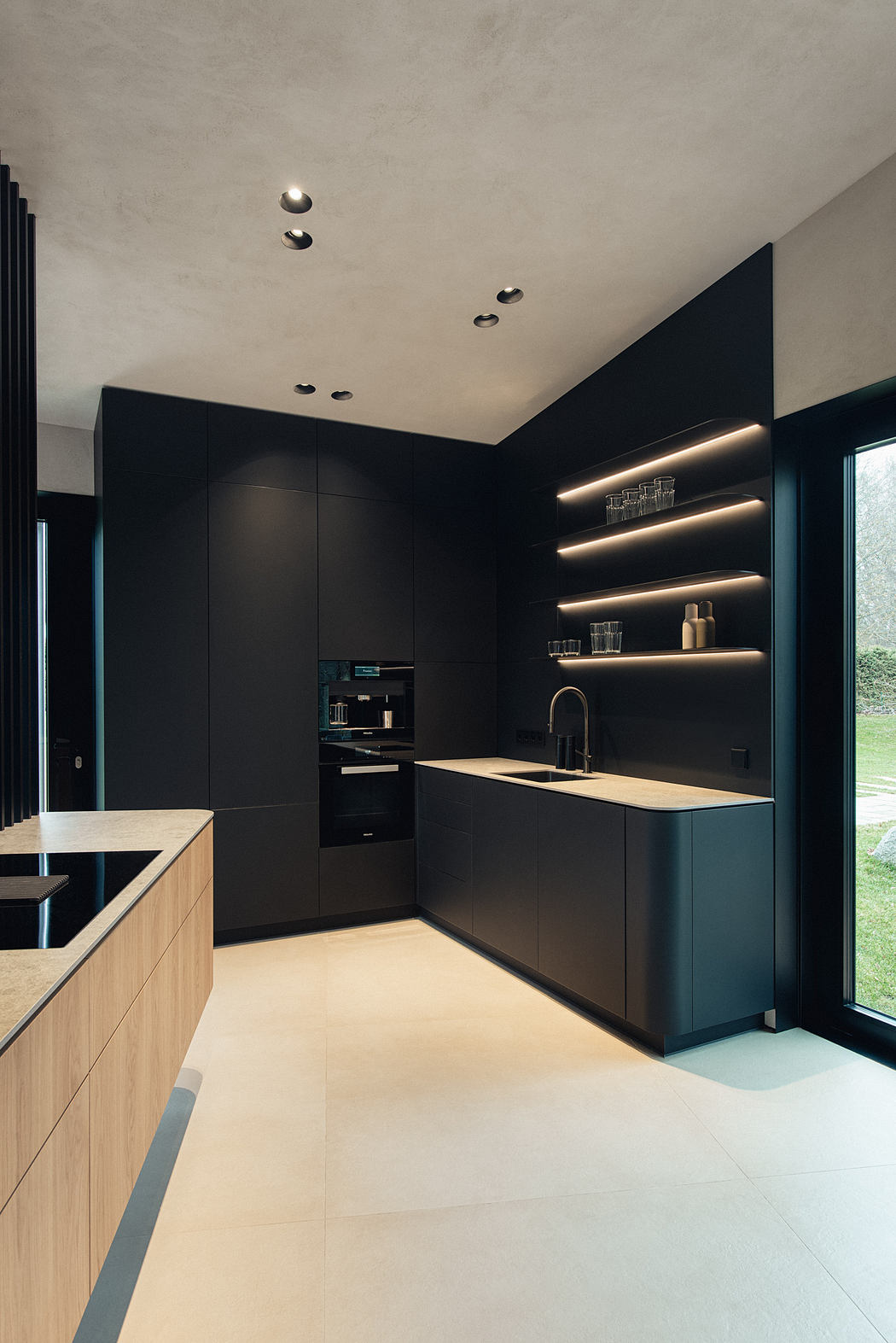 Sleek, modern kitchen design featuring black cabinetry, integrated lighting, and natural wood accents.