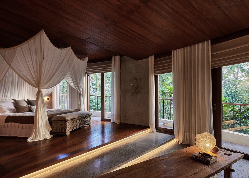 A cozy and serene bedroom with a canopied bed, wooden ceiling, and lush forest views.