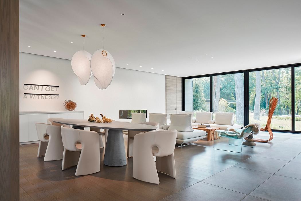 Modern dining room with minimalist furniture and large windows.