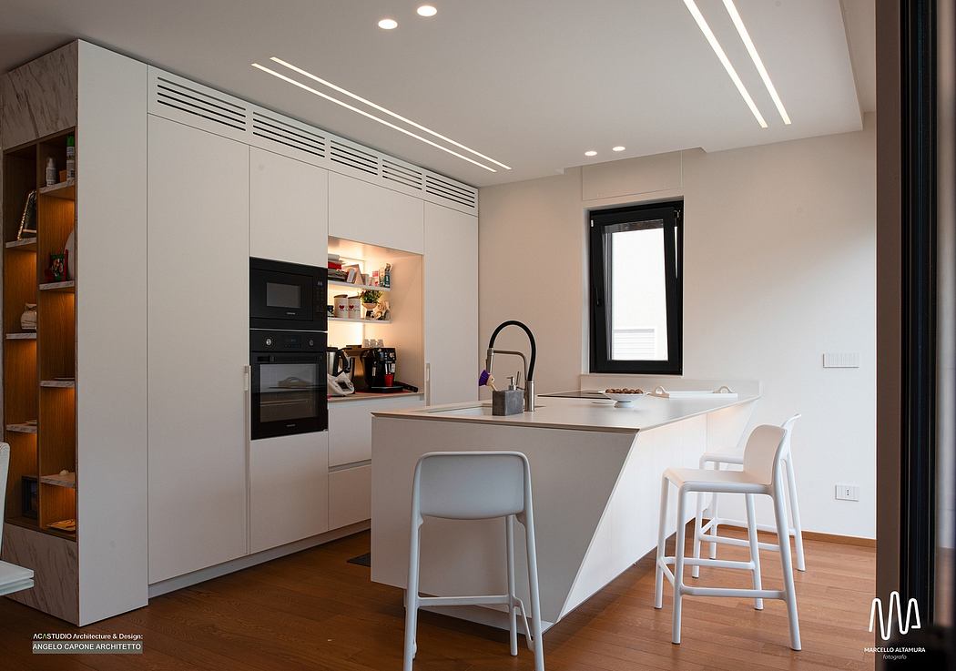 Minimalist kitchen with sleek cabinetry, recessed lighting, and breakfast bar seating.