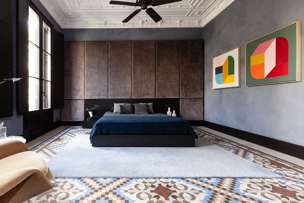 Chic bedroom with patterned floor tiles and abstract art.