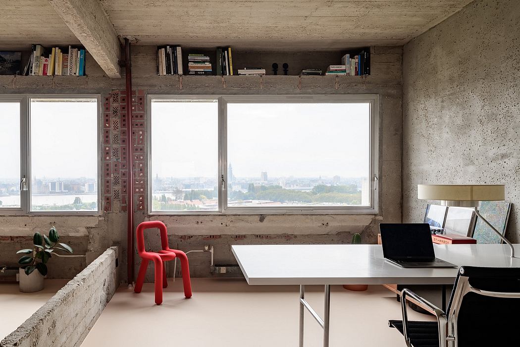 Minimalist office with exposed concrete and city view.