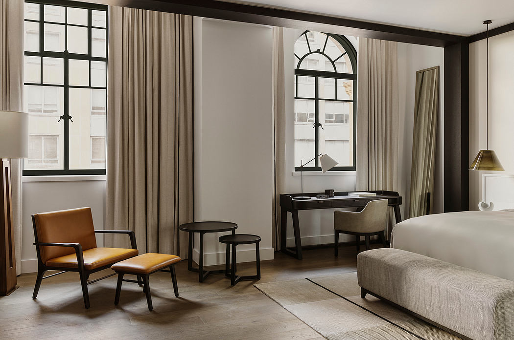 Elegant room with neutral tones, large windows, and stylish furniture.