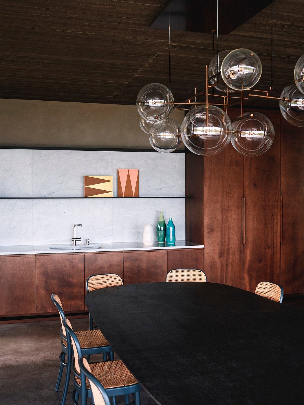 Contemporary dining room with bubble pendant lights and wooden accents.