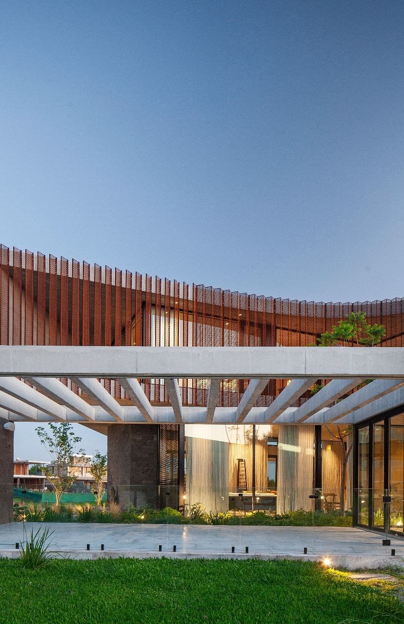 Modern building with slatted wood design and glass façade at twilight.