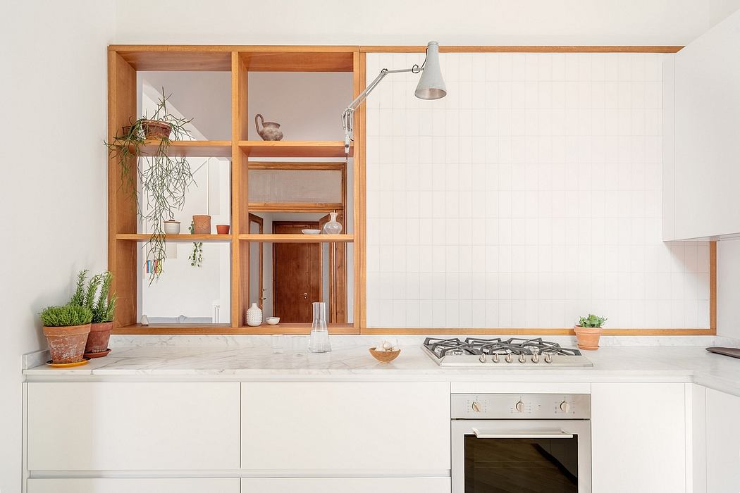 Contemporary kitchen with wooden shelves, white cabinetry, and a gas stove.