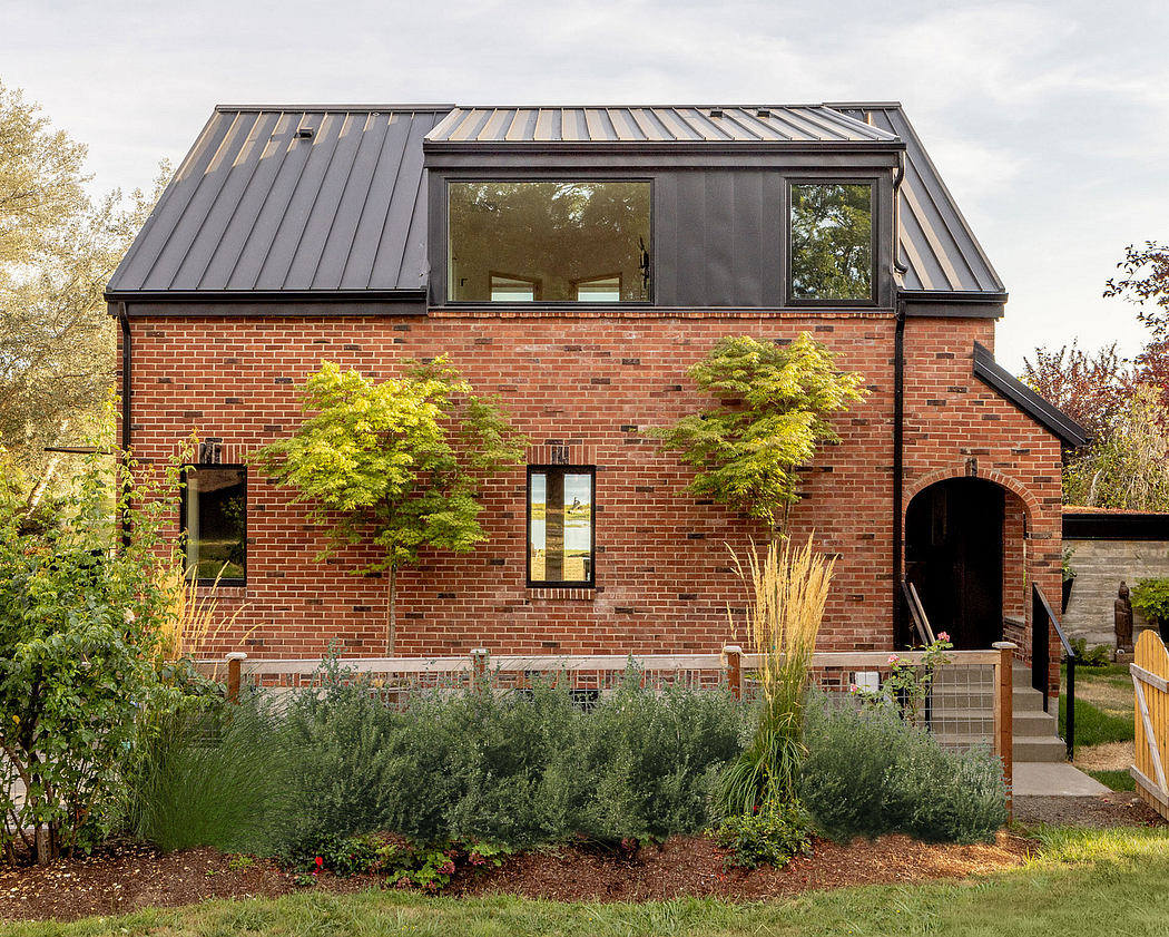 Contemporary brick house with large windows and metal roof.