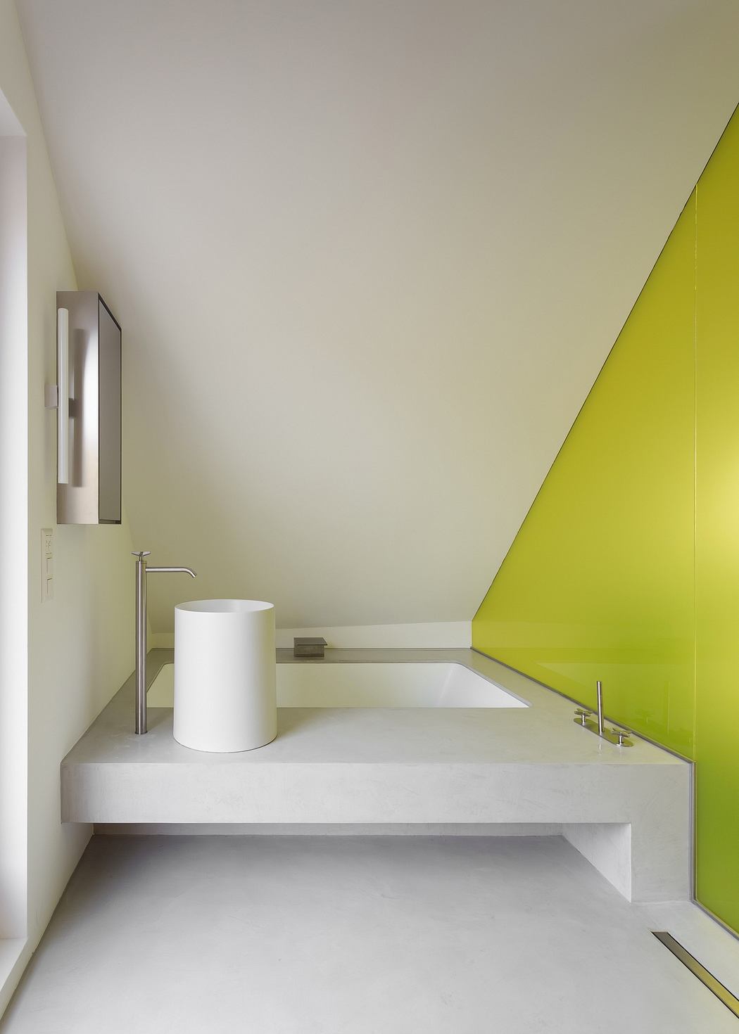 Modern bathroom with minimalist white vanity, circular basin, and vibrant green accent wall.