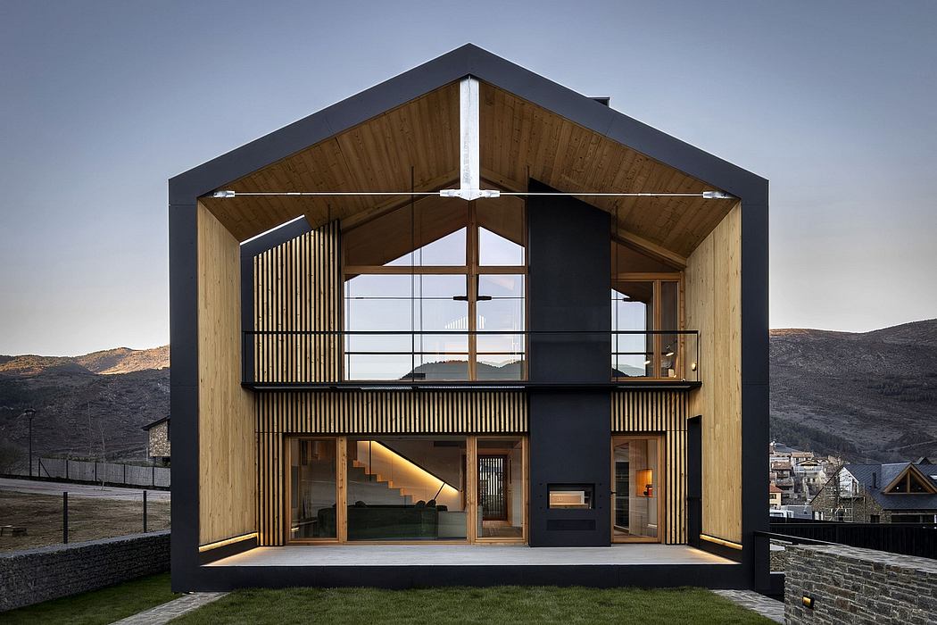 A modern, two-story wooden cabin with a mix of black and natural wood elements.