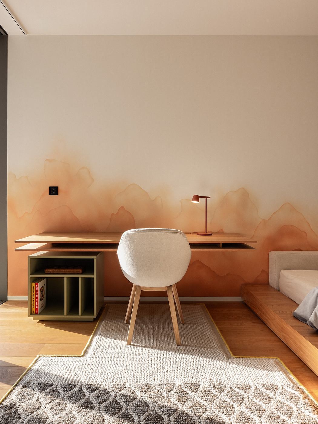 Contemporary study corner with abstract wall art, wooden desk, and white chair.