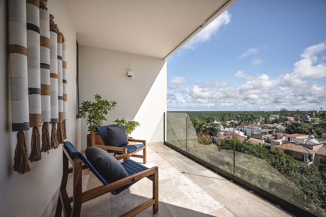 Balcony with chairs overlooking a scenic view.