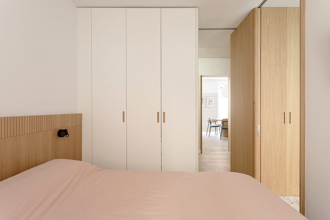 Minimalist bedroom with clean lines, neutral colors, and wooden accents throughout.