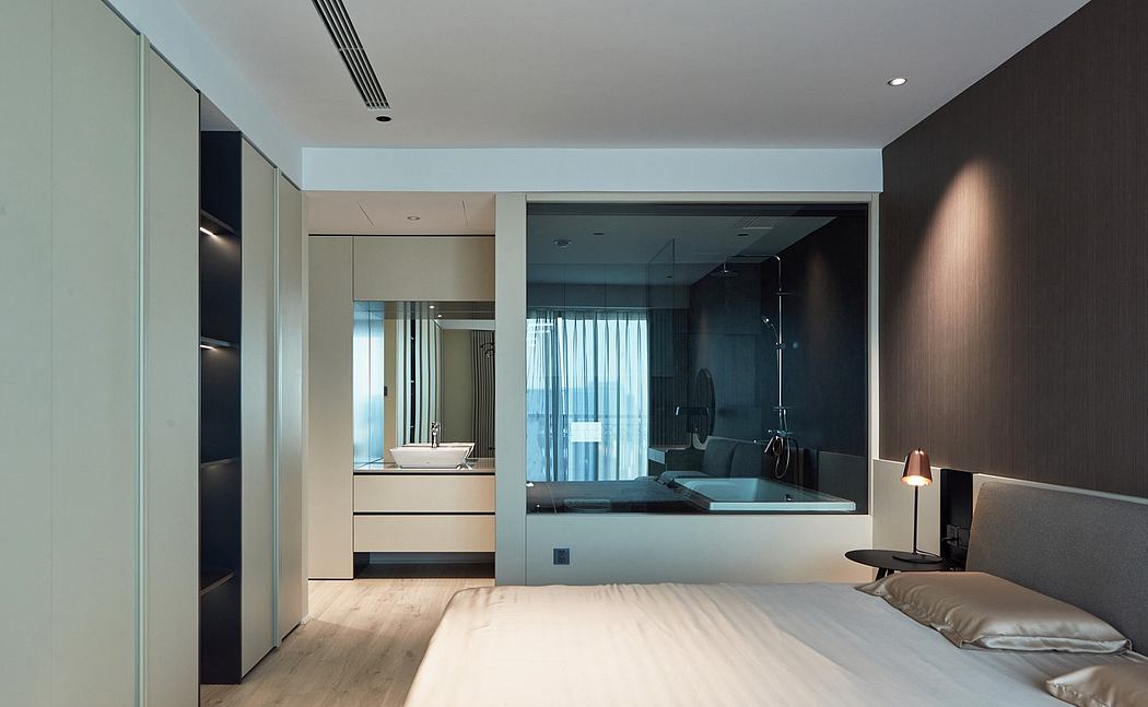 Contemporary bedroom with sleek, minimalist design elements and an open bathroom layout.