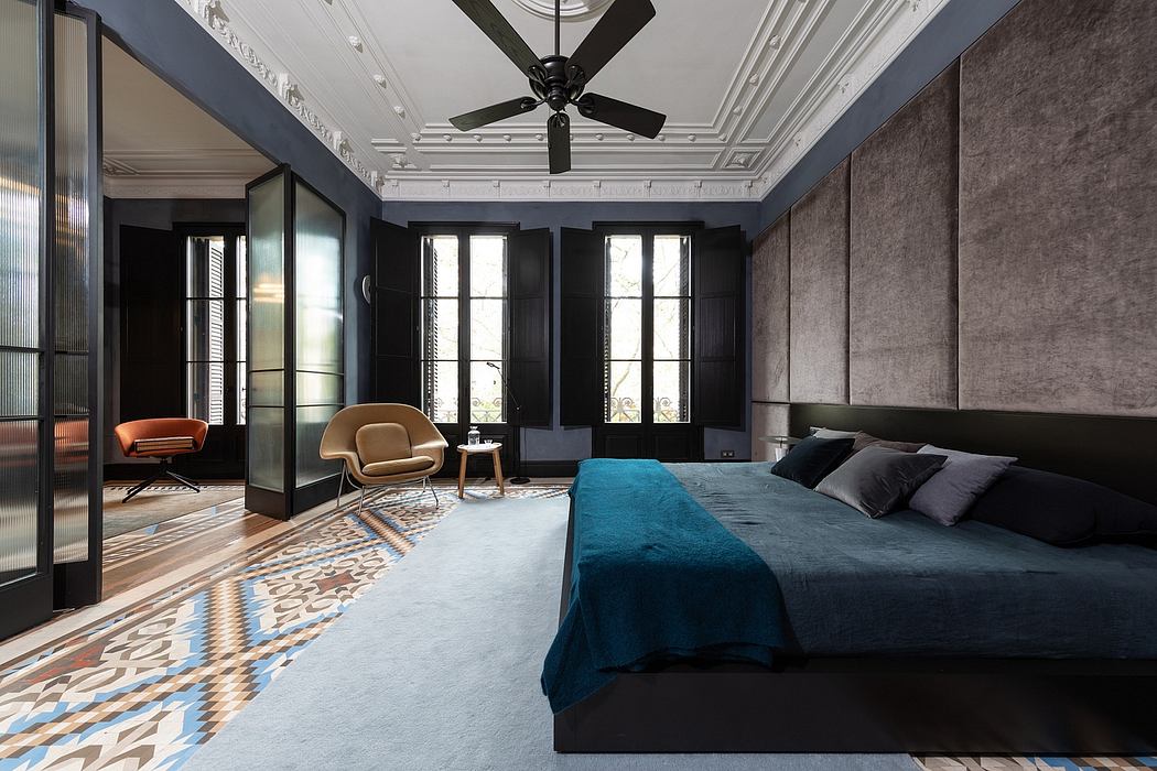 Elegant bedroom with patterned floor, large windows, and sleek furniture.