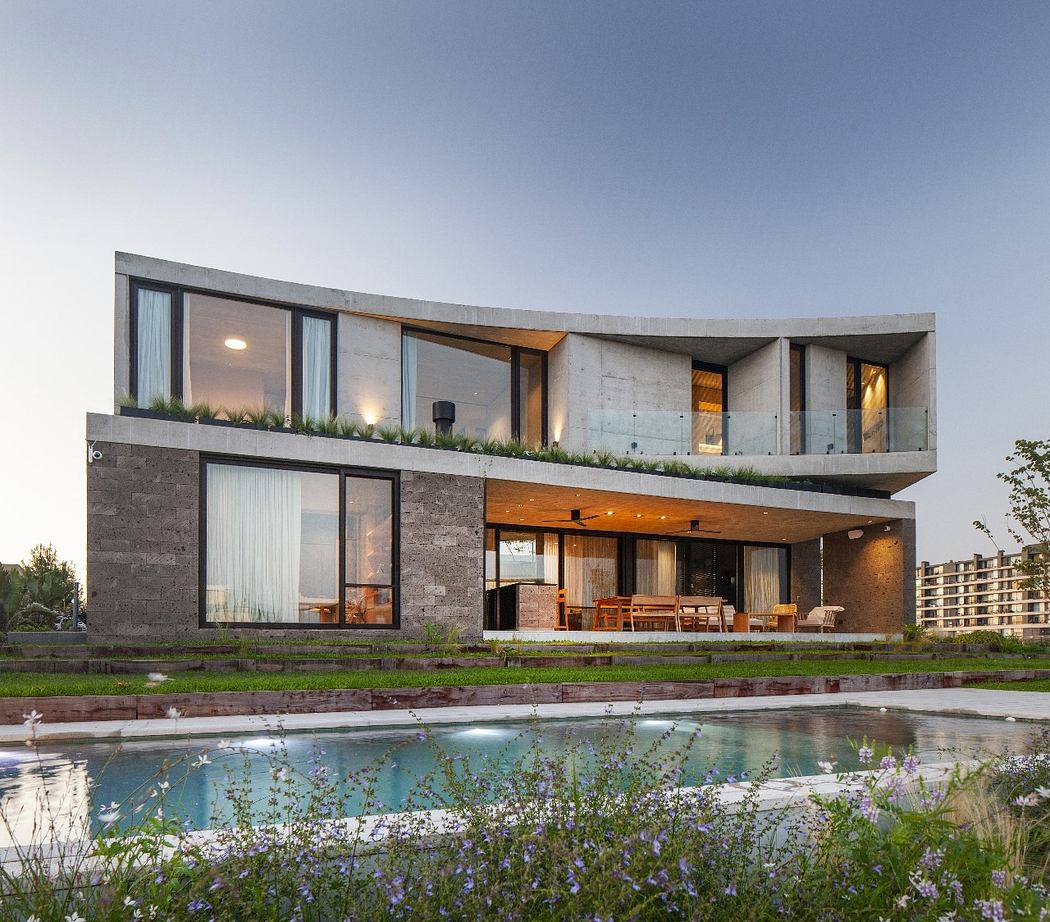 Contemporary two-story house with large windows and pool.