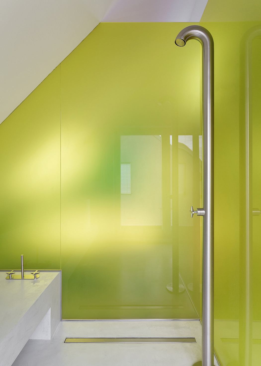 Vibrant green shower enclosure with sleek chrome fixtures and minimalist design.