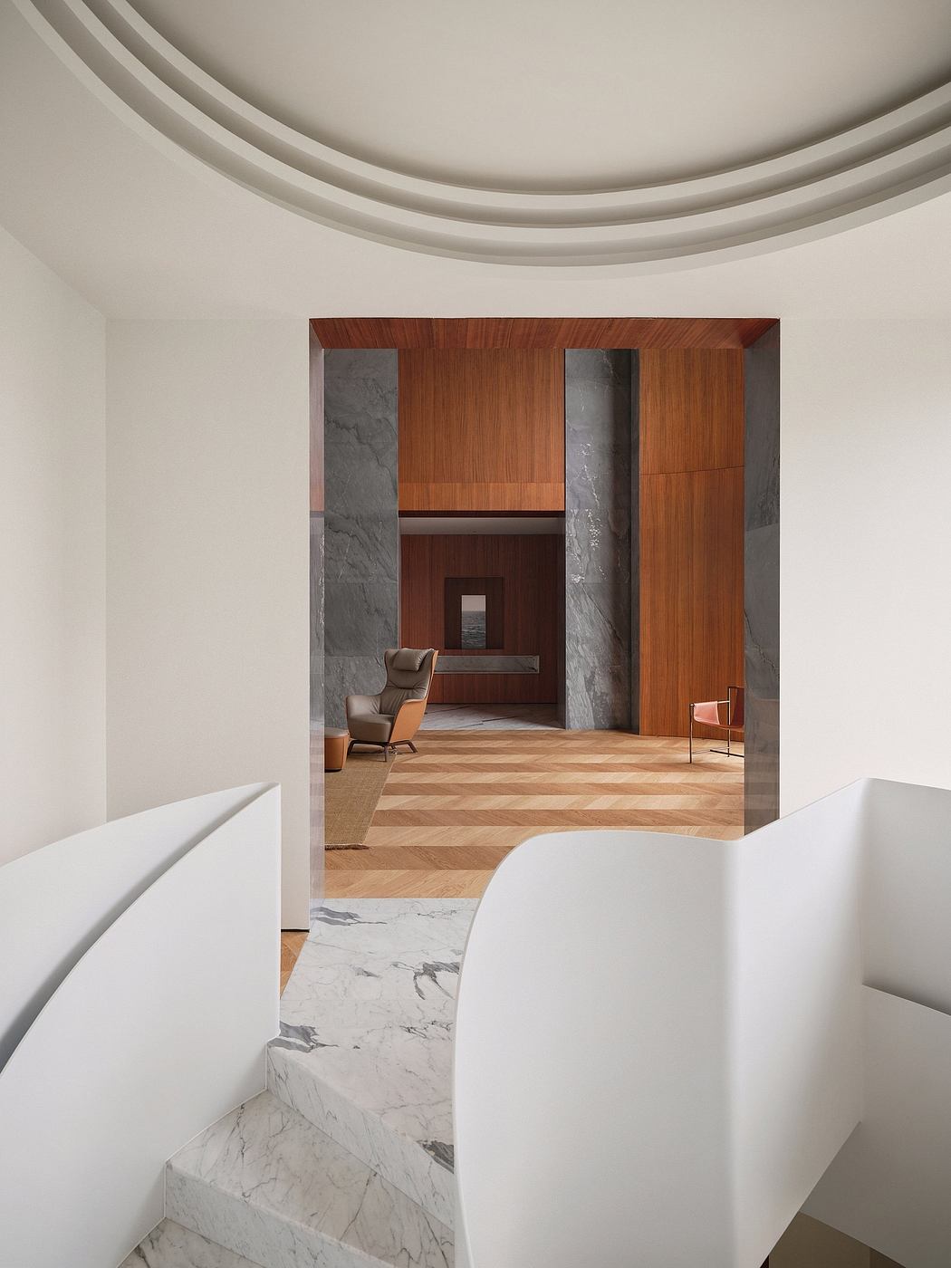 Elegant interior design featuring curved ceilings, marble, and wood accents.