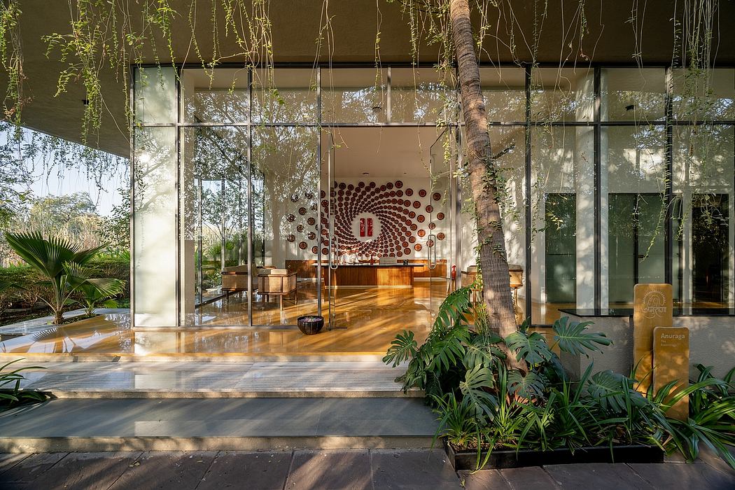 Stunning modern architecture with lush tropical landscaping, glass walls, and a bold art installation.