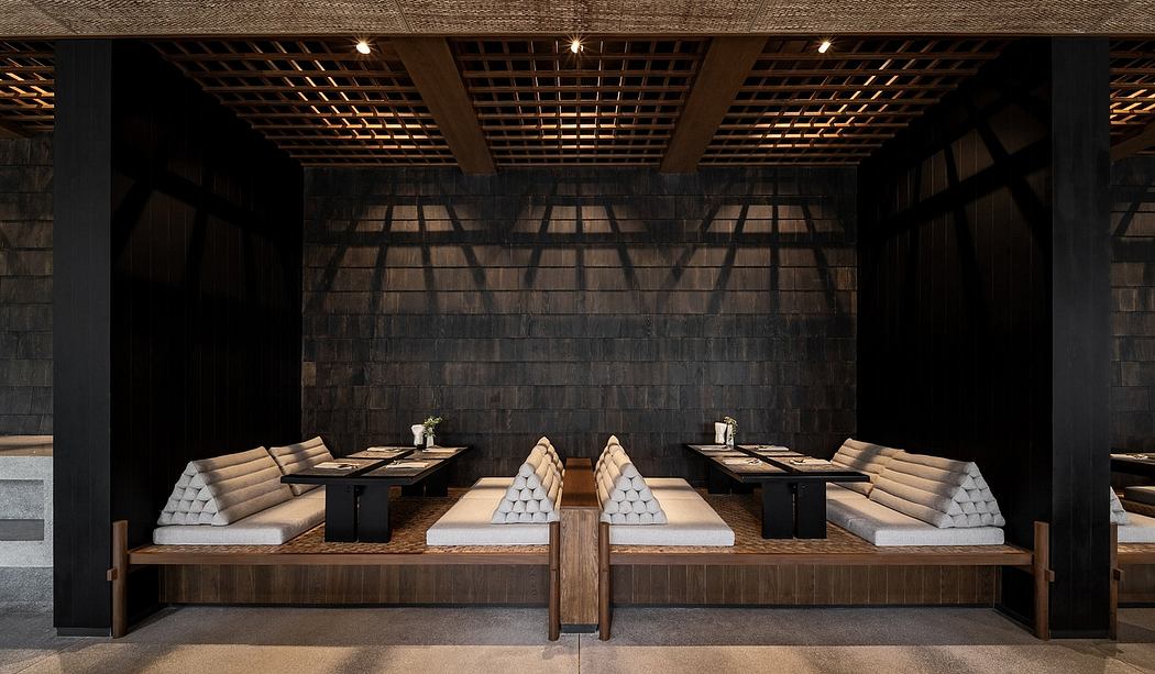 Modern dining space with wooden seating and a lattice ceiling.