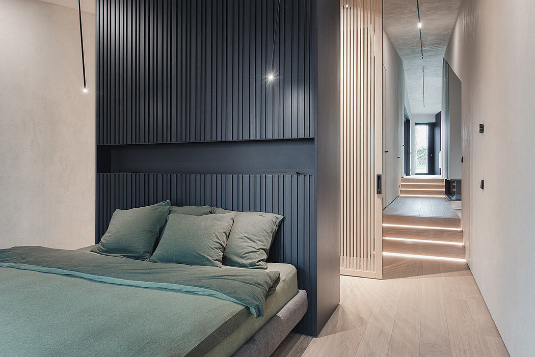 Minimal bedroom with dark paneled walls, recessed lighting, and a clean, modern corridor.