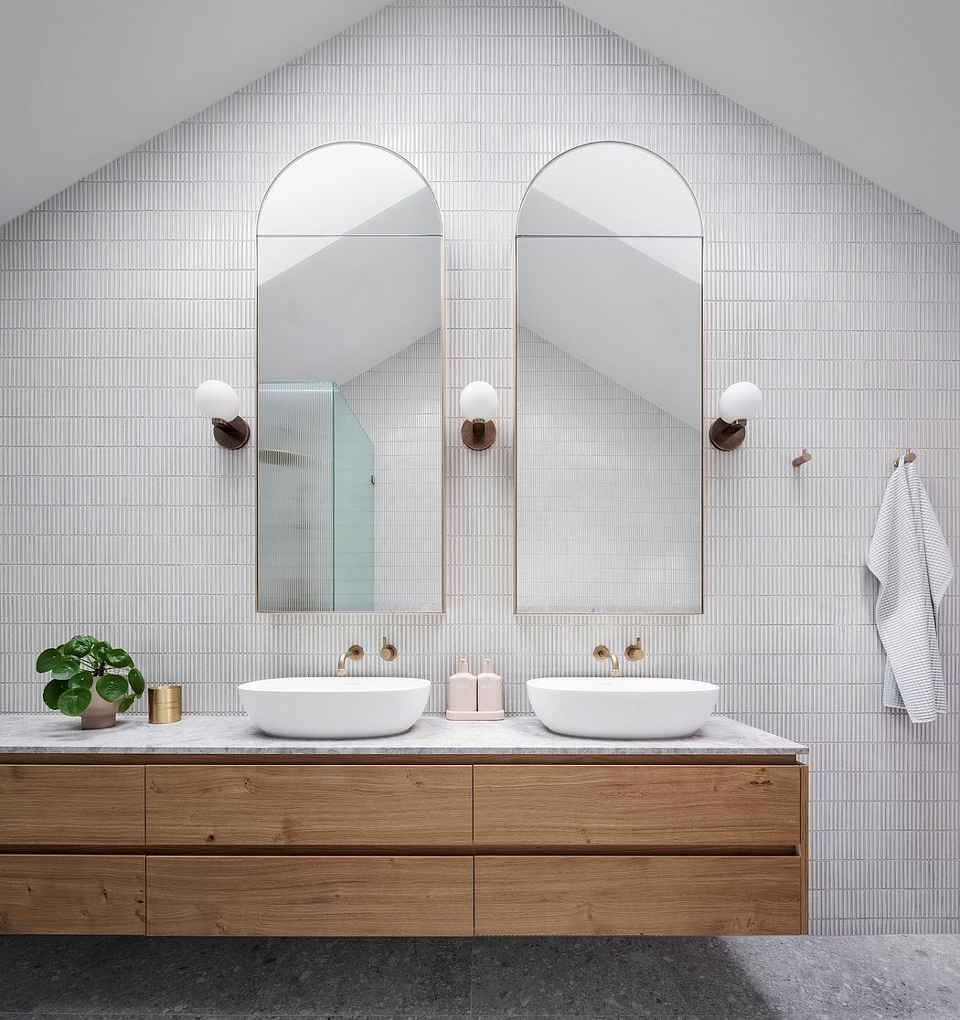 Sophisticated bathroom design with double vanity, arched mirrors, and striking tile pattern.