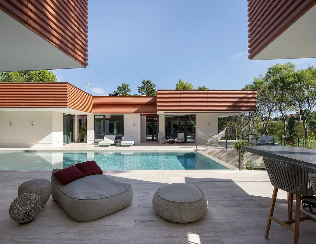 Sleek modern architecture with a focus on clean lines, natural materials, and an inviting pool.