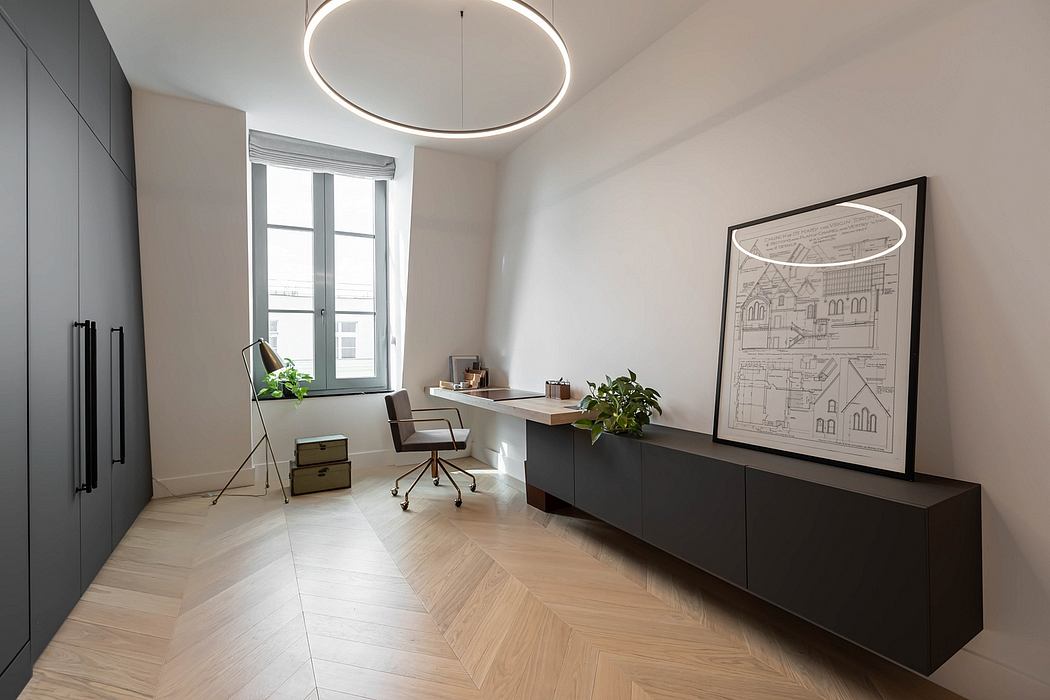 Modern minimalist office interior with circular light fixture and framed artwork.
