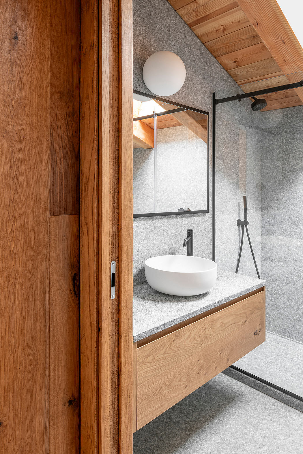 Rustic bathroom with wooden accents, modern basin, and geometric mirror frame.