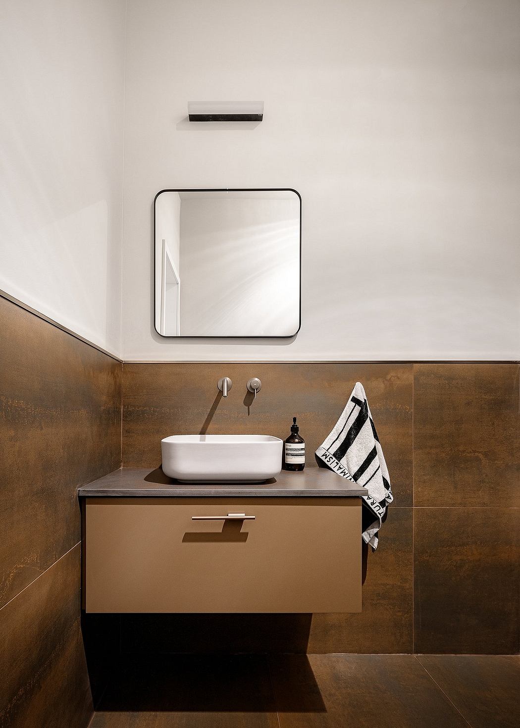Modern bathroom with floating vanity, vessel sink, and rectangular mirror.
