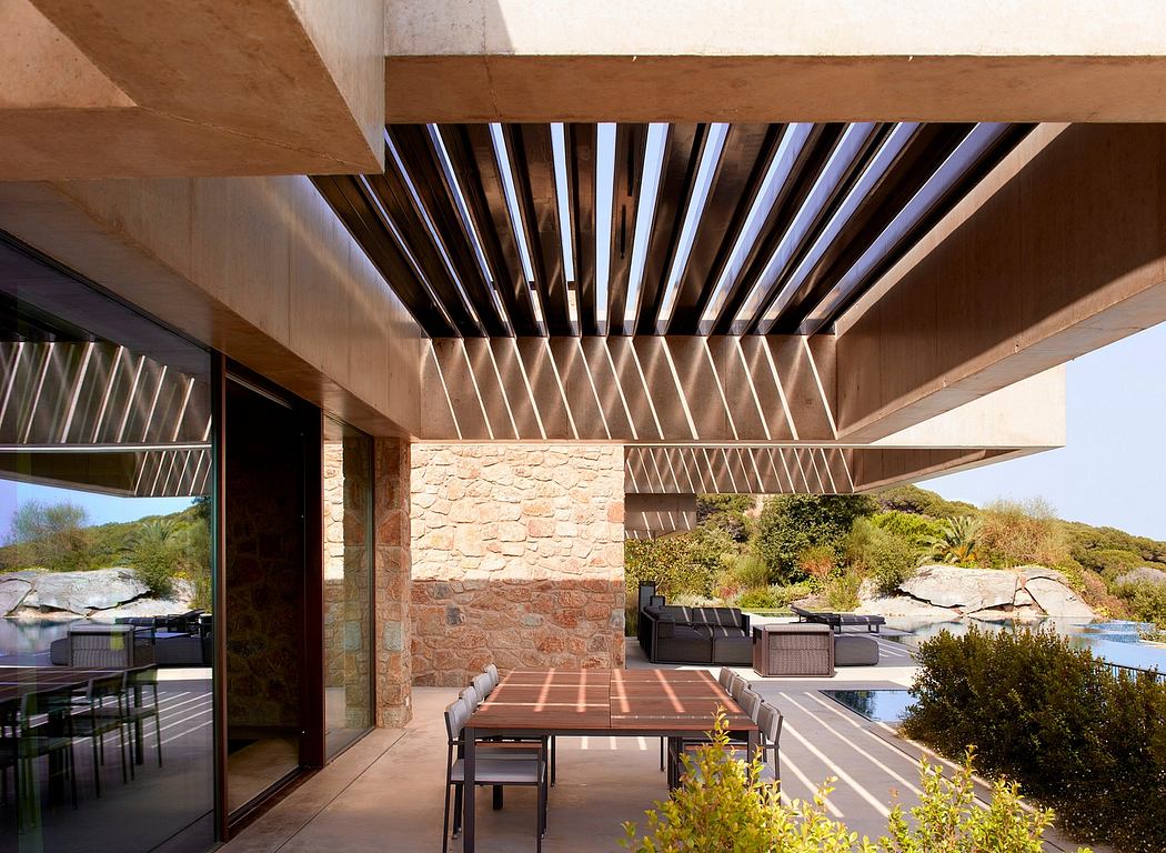 Modern terrace with stone walls, louvred roof, and outdoor furniture.