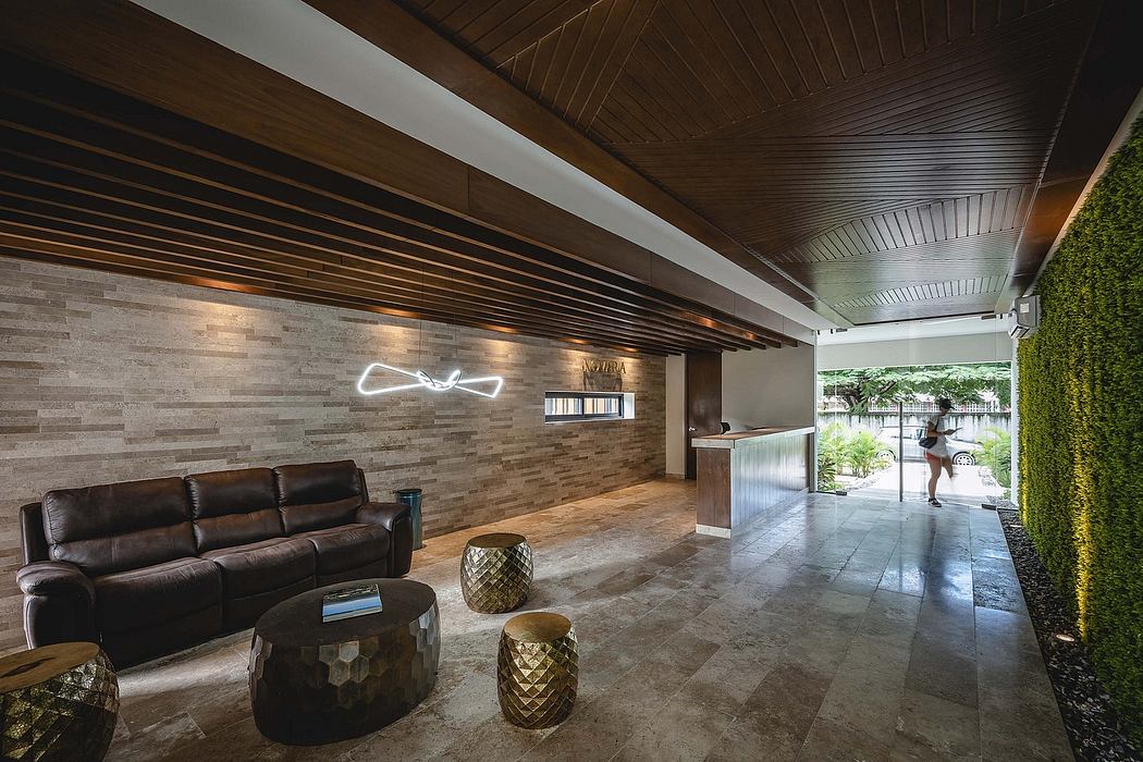 Modern lobby with sleek furniture and decorative lighting.