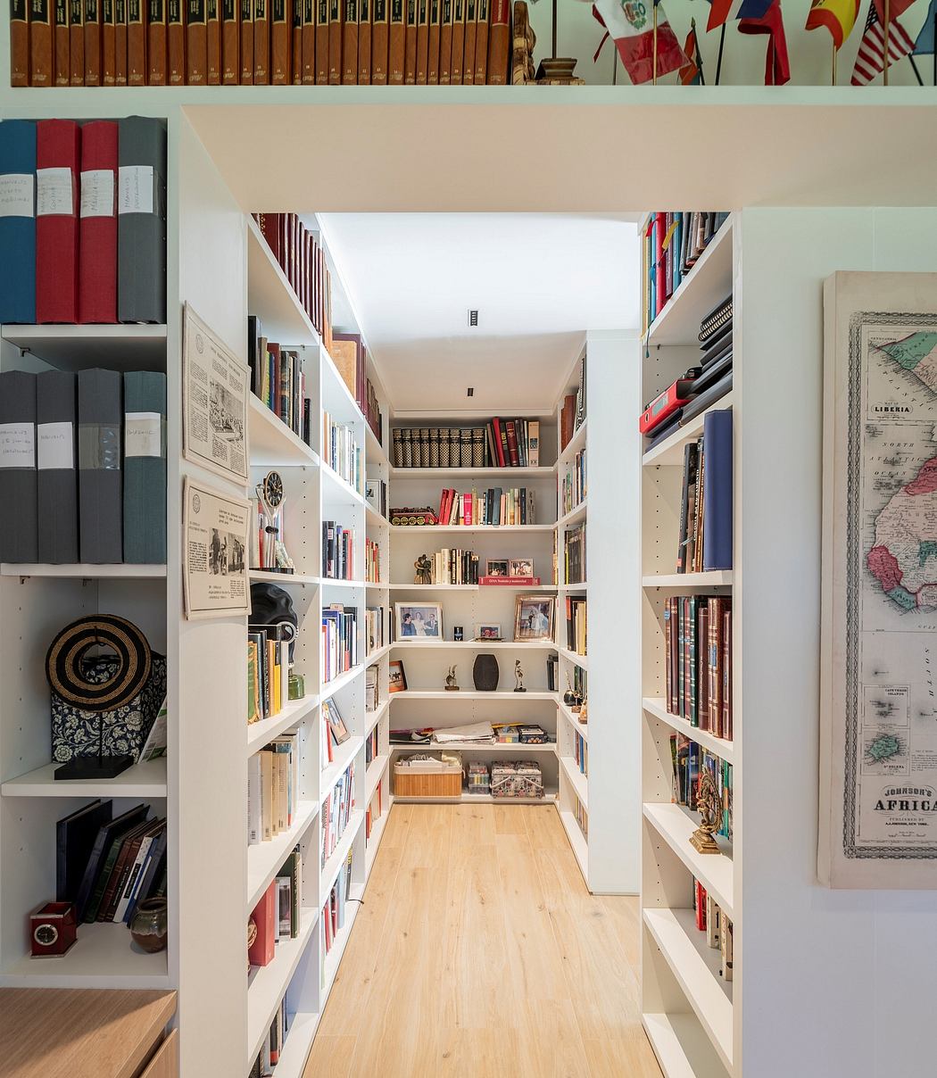 Cozy home library with bookshelves lining a narrow corridor.