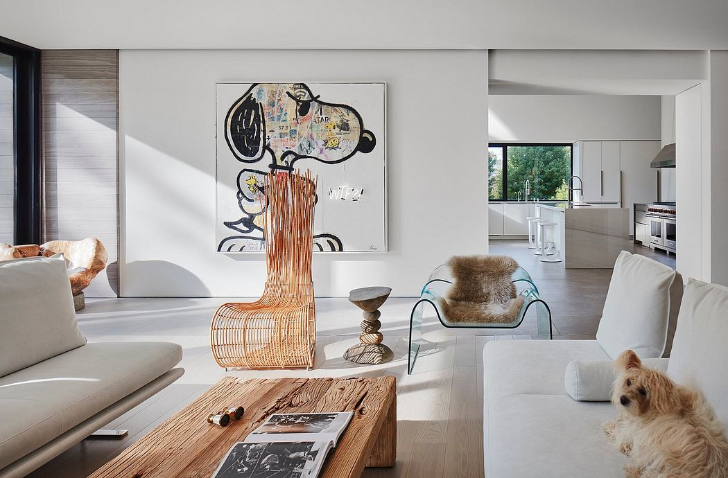 Contemporary living room with art, sleek furniture, and a dog.