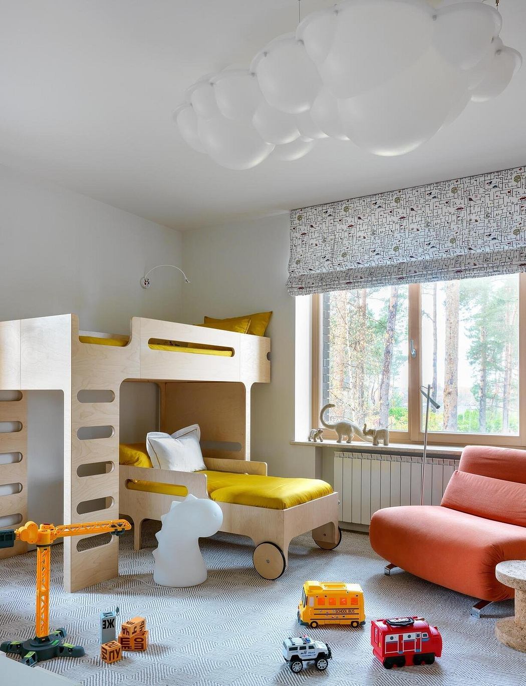 A bright, colorful children's room with a geometric pattern wall, built-in bunk beds, and playful decor.