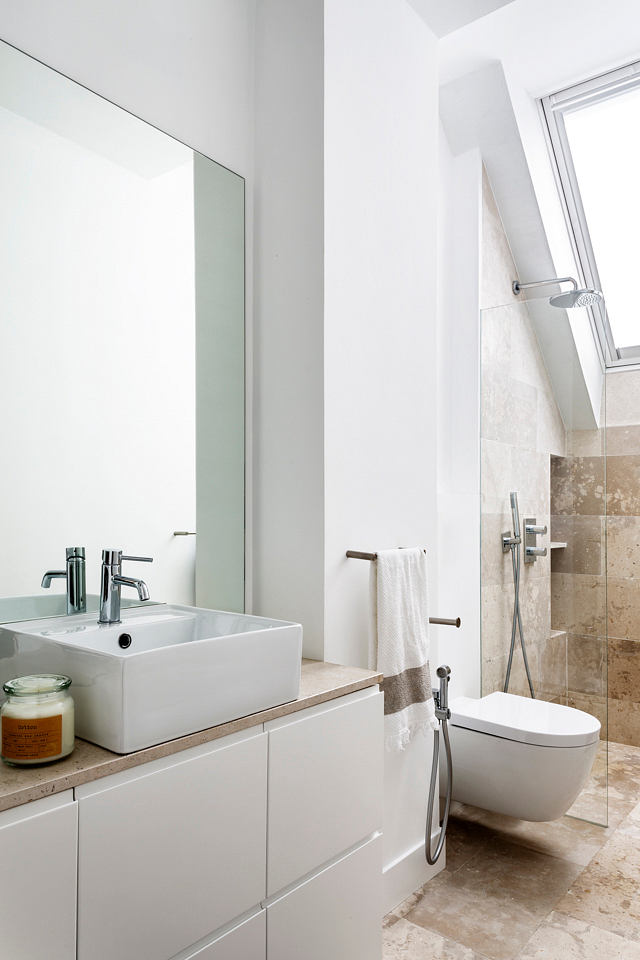 Modern bathroom with a sink, mirror, and walk-in shower.