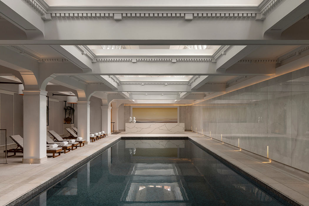 Elegant indoor pool with neoclassical design elements.