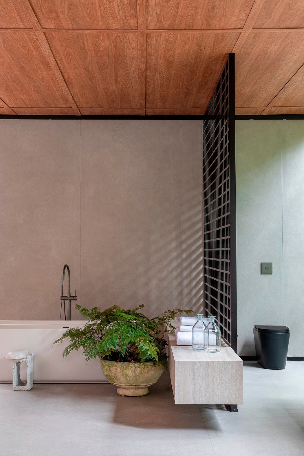 Minimalist interior with wooden ceiling, bench, plant, and a slatted partition