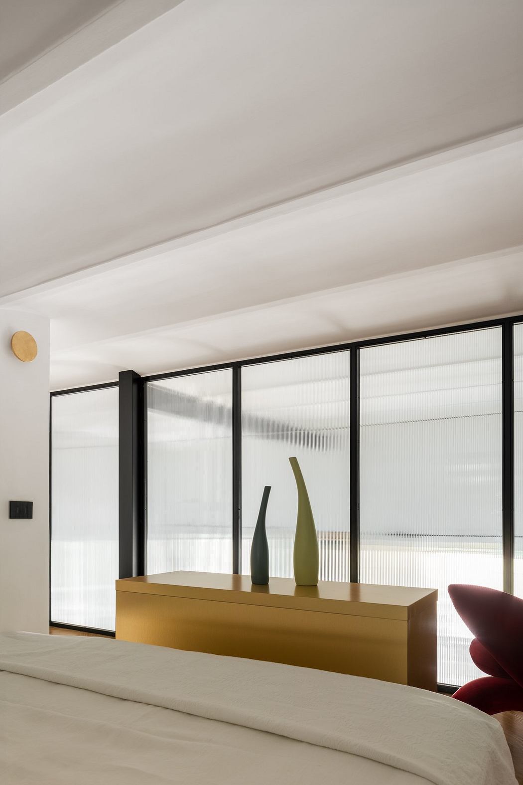 Minimalist room with sheer curtains and sculptural vases.