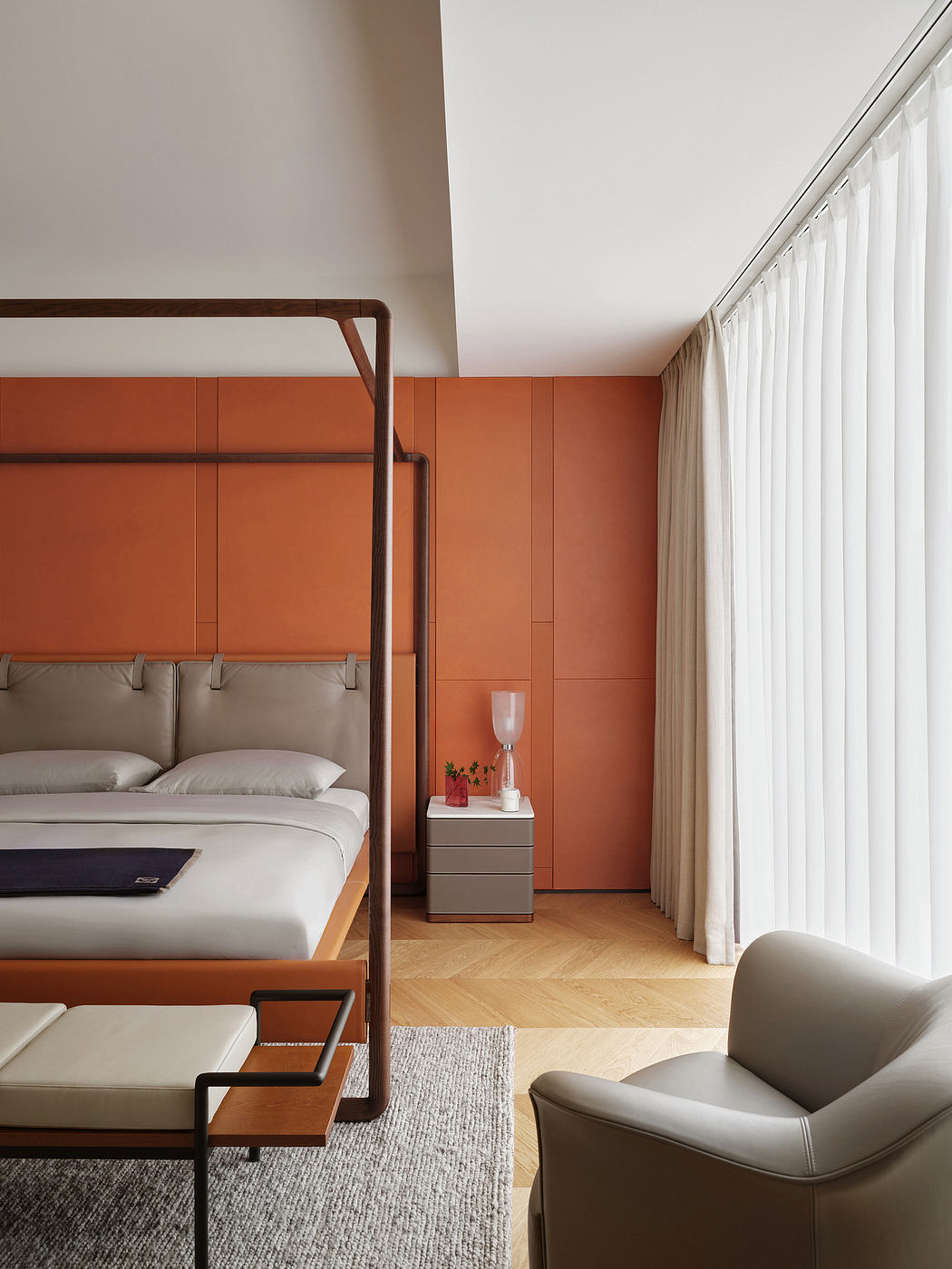 A modern bedroom with an orange accent wall, wooden bed frame, and minimalist decor.