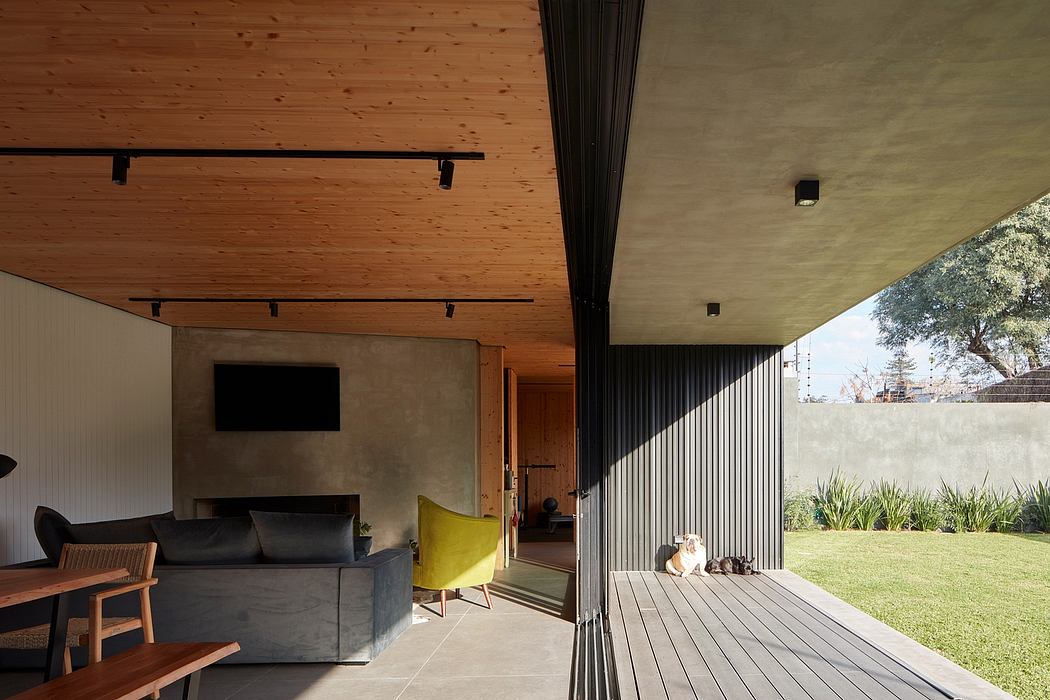 Modern patio with wooden ceiling, furniture, and a dog lying on the concrete floor