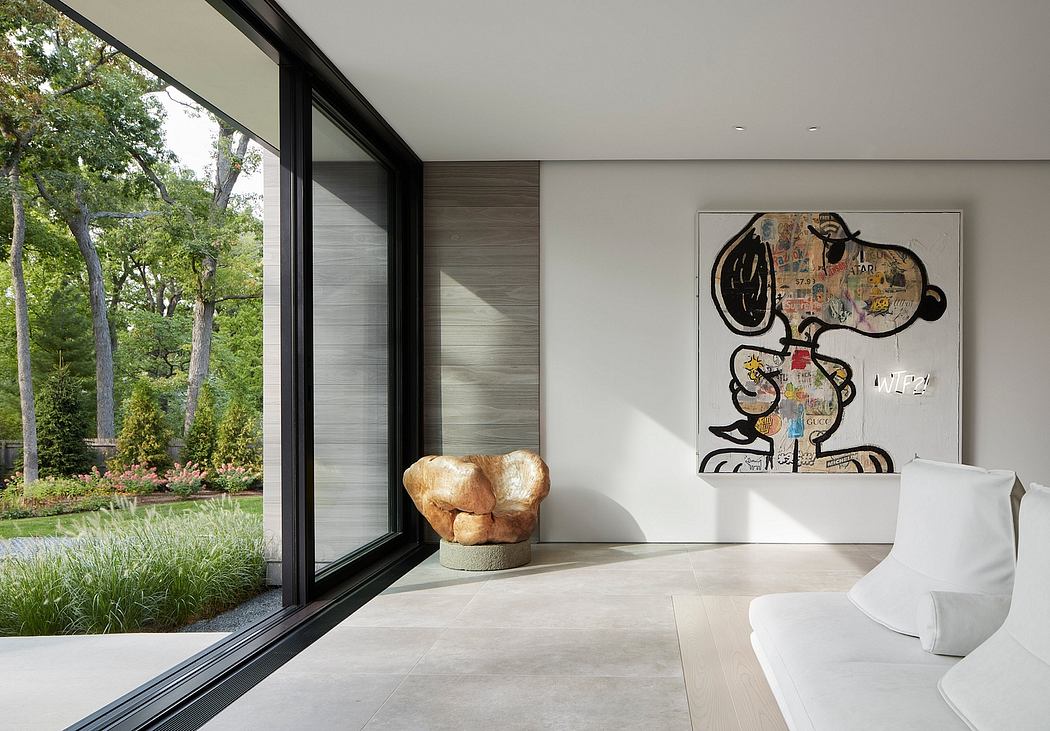Modern room with large windows, artwork on the wall, and unique chair.