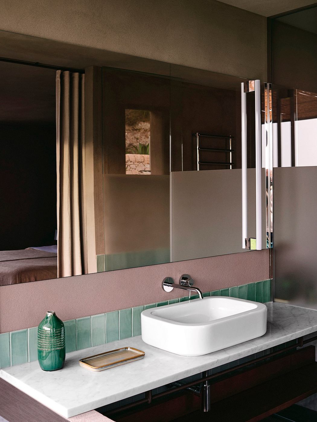 Contemporary bathroom with a vessel sink and green tile trim.