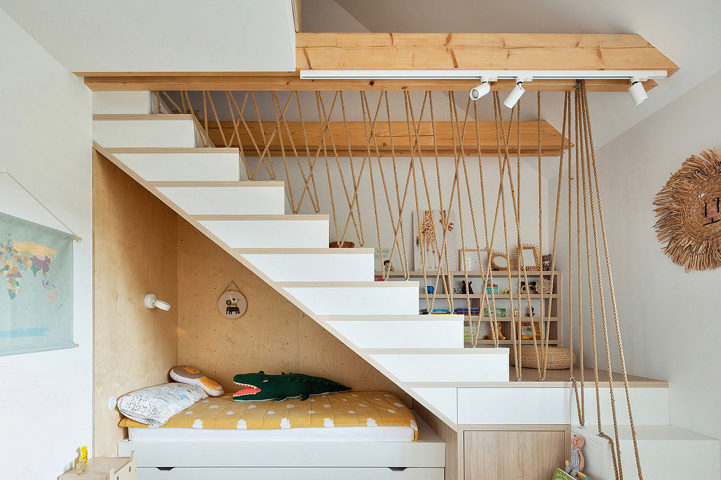 Compact under-stair nook with built-in bed and storage, accented by