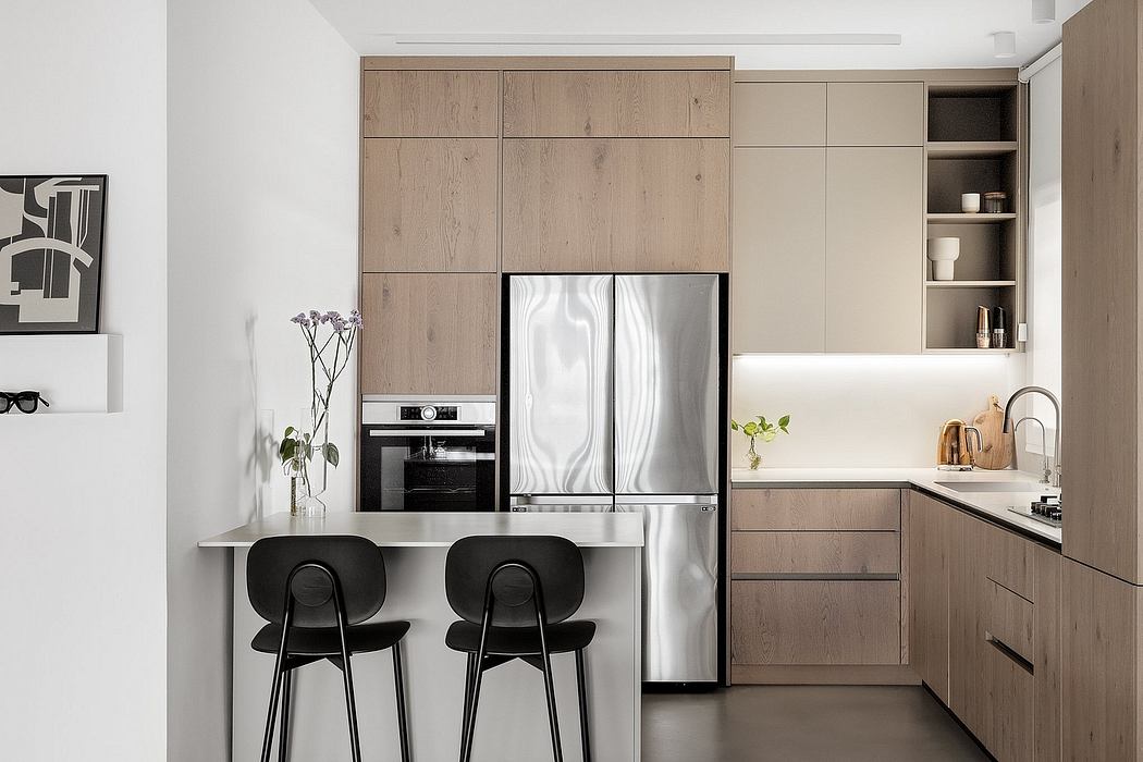 Minimalist kitchen with wood accents and black stools.