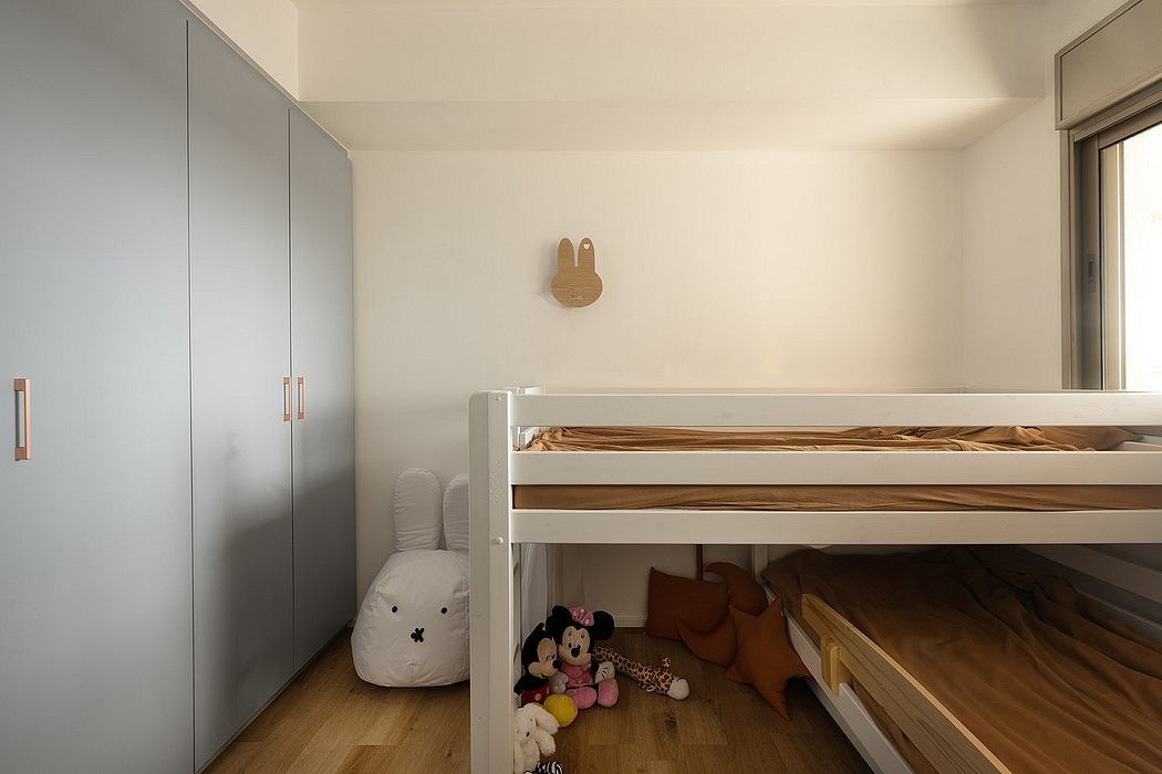 Minimalist children's room with a bunk bed and plush toys.